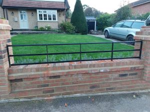 Custom made metal railing on a garden wall