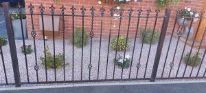 Decorative wrought iron railing on a slope