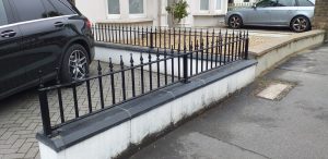 Short wrought iron railing on a dwarf wall