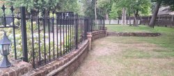 curved iron railings on a low wall