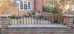 low wall railing using prefabricated scrolls and hybrid bar spacing